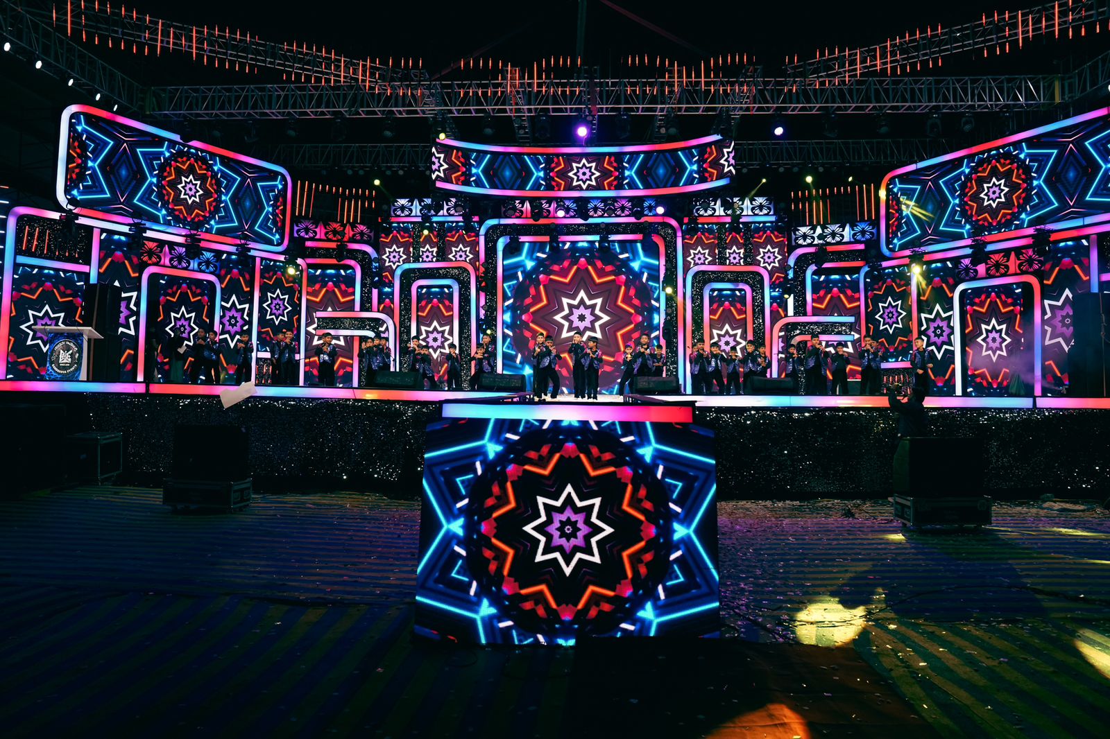 Elaborate LED mandala stage design with neon geometric patterns for large-scale event production