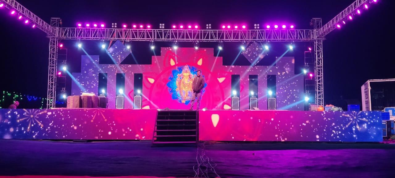 Outdoor festival stage with pink LED wall, professional truss lighting rig, and sound system in Bangalore
