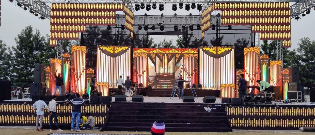 Large outdoor stage with LED pillar panels being set up during daytime for event production in Bangalore