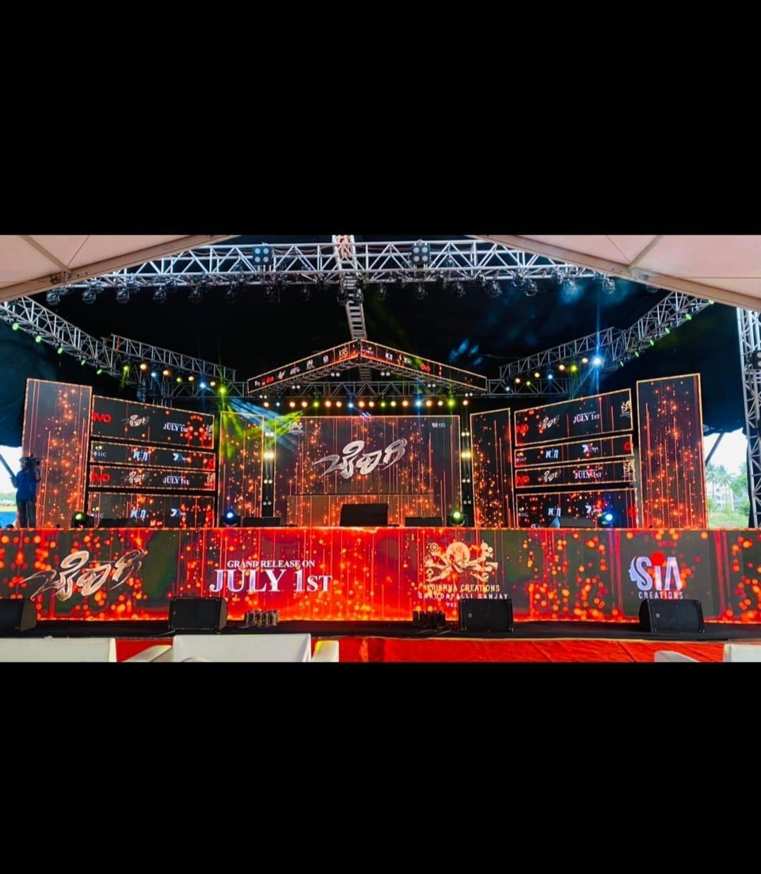 Kannada movie grand release event stage with red and orange LED wall and professional lighting in Karnataka