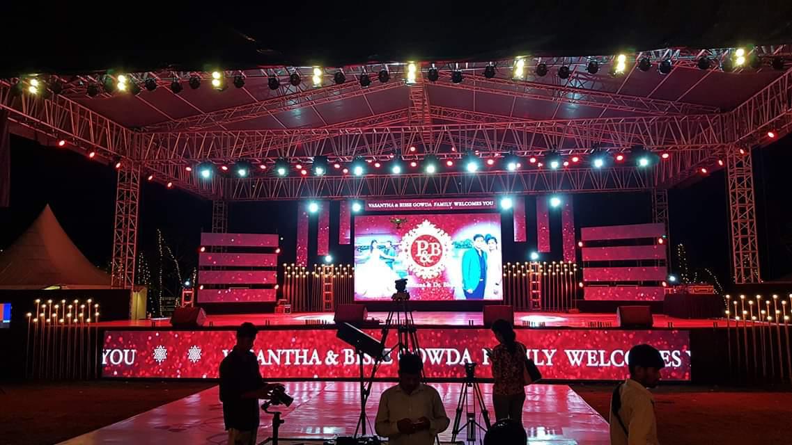 Wedding reception stage with LED wall display, truss lighting rig, and professional setup in Bengaluru