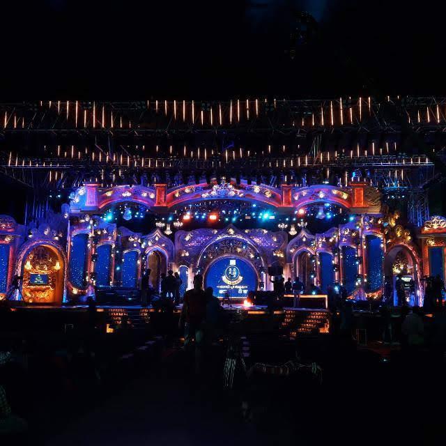 Grand ornate stage with arched LED wall design and blue-gold lighting for large-scale event in Bangalore
