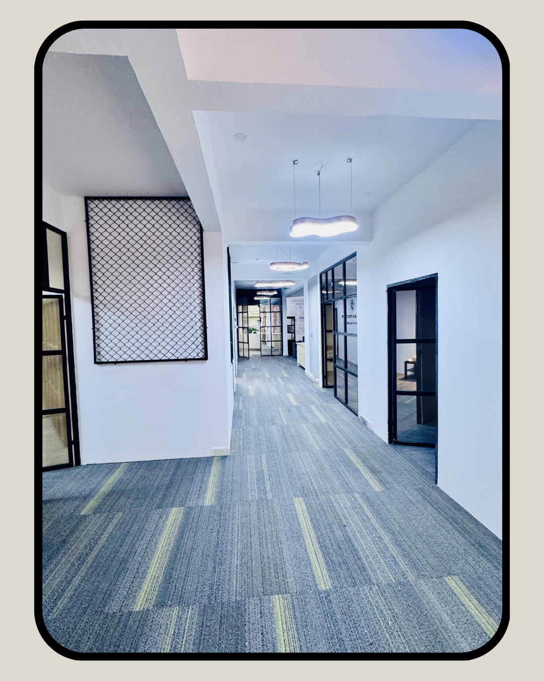 Spacious office lobby with decorative wall panel and modern interiors at Supreme Media Productions