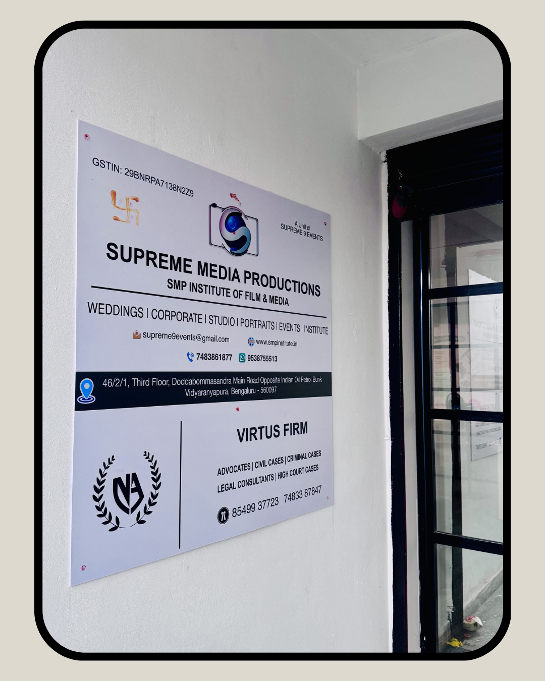 Supreme Media Productions office signboard displaying services including weddings corporate events and studio production